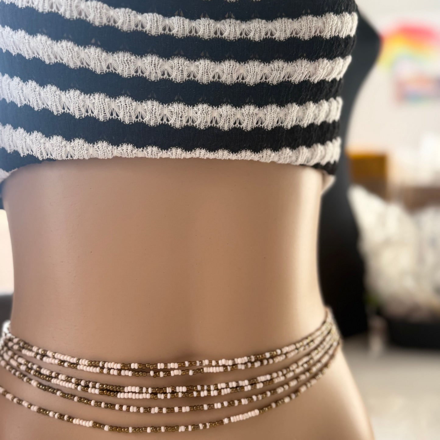 bronze beige tie on waist beads on waist, African waist beads, clasped waist beads, Bare Bronze waist beads worn by mannequin in natural light – neutral toned body jewellery for grounding and confidence.