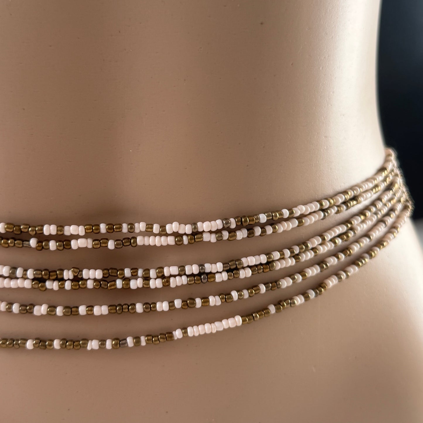 bronze beige tie on waist beads on waist, African waist beads, clasped waist beads, Bare Bronze waist beads worn by mannequin in natural light – neutral toned body jewellery for grounding and confidence
