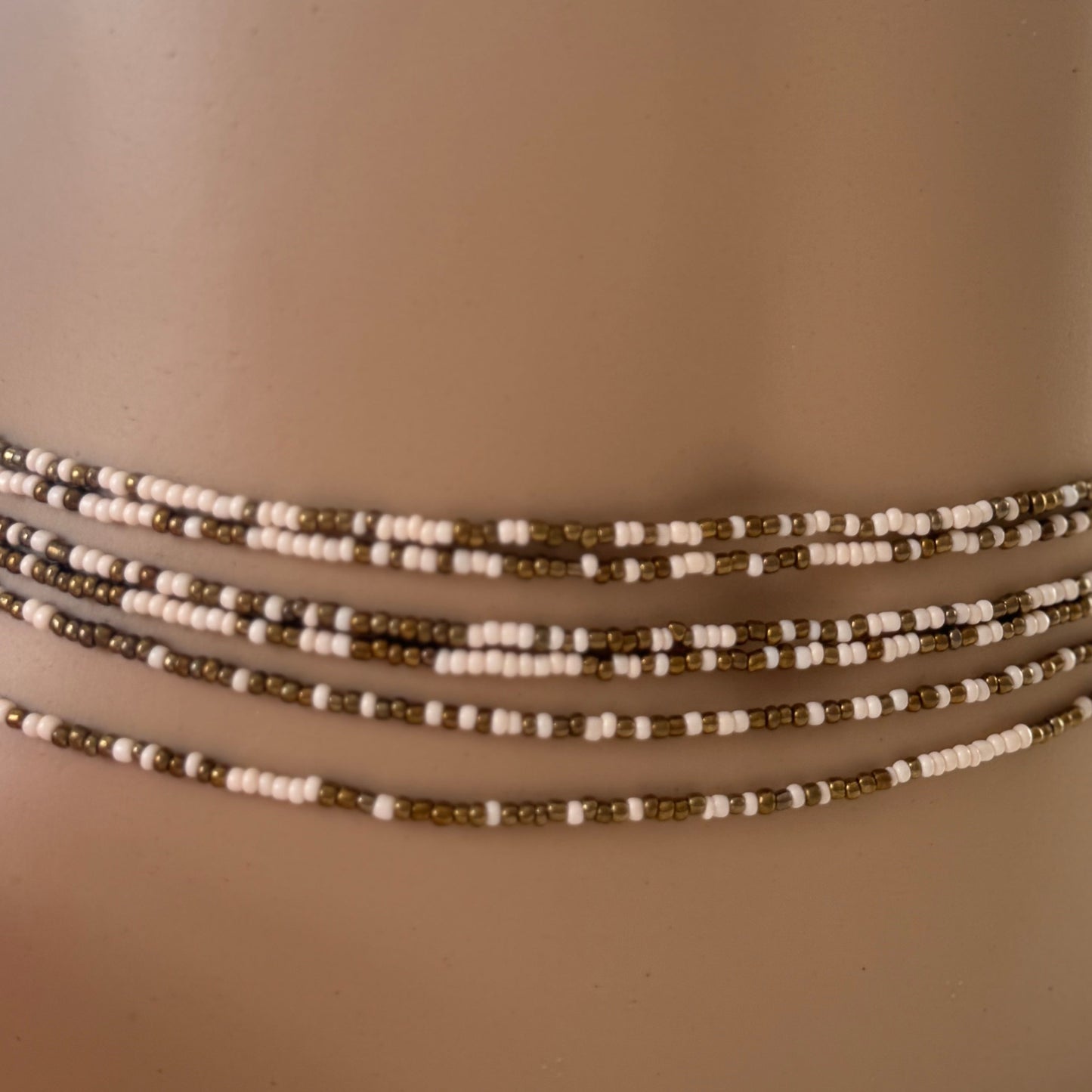 bronze beige tie on waist beads on waist, African waist beads, clasped waist beads, Bare Bronze waist beads worn by mannequin in natural light – neutral toned body jewellery for grounding and confidence