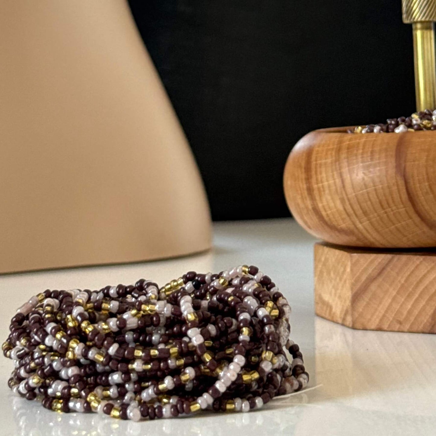 Earth & Ether waist beads for women, handcrafted with warm brown, soft lilac, and gold glass beads. Translucent lilac accents blend with earthy tones, symbolising balance, intuition, and feminine energy. Adjustable waist beads designed for self-love, spiritual growth, and grounded confidence.