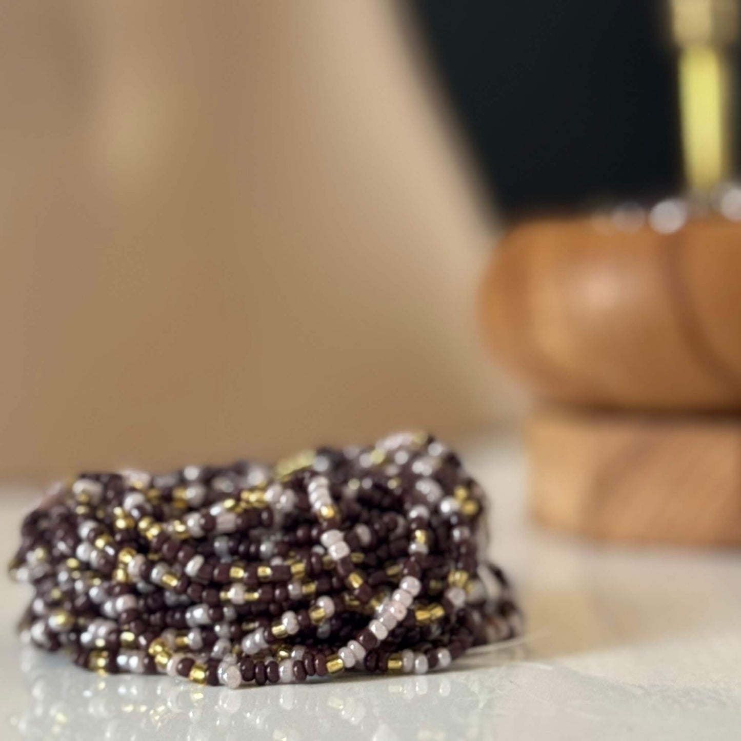 Earth & Ether waist beads for women, handcrafted with warm brown, soft lilac, and gold glass beads. Translucent lilac accents blend with earthy tones, symbolising balance, intuition, and feminine energy. Adjustable waist beads designed for self-love, spiritual growth, and grounded confidence.