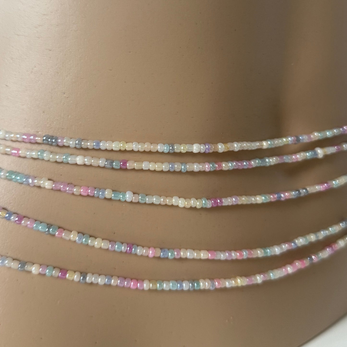 Close-up of Whispered Dream pastel waist beads featuring soft pink, lilac, baby blue, and cream glass beads. Handcrafted feminine waist jewelry designed for calm, balance, and gentle energy. Perfect accessory for women embracing softness, self-love, and everyday goddess vibes.