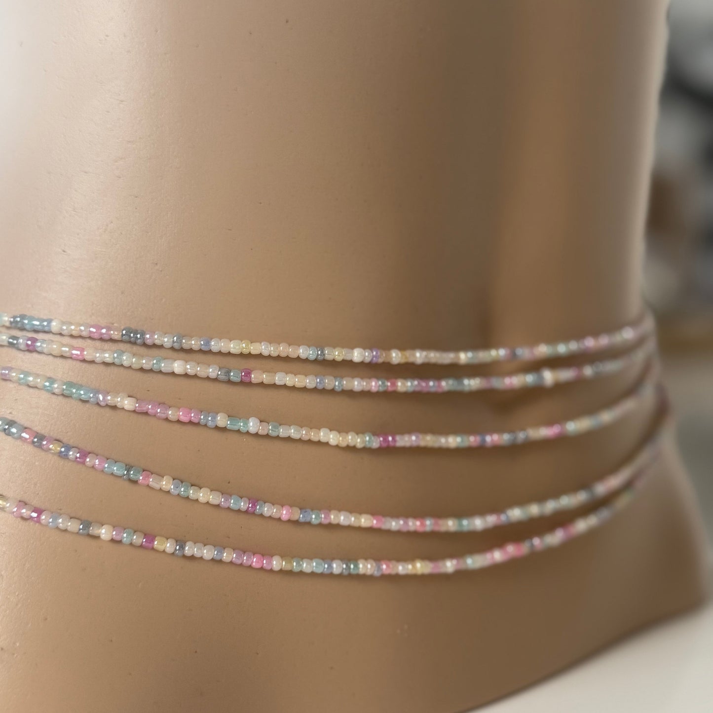 Close-up of Whispered Dream pastel waist beads featuring soft pink, lilac, baby blue, and cream glass beads. Handcrafted feminine waist jewelry designed for calm, balance, and gentle energy. Perfect accessory for women embracing softness, self-love, and everyday goddess vibes.