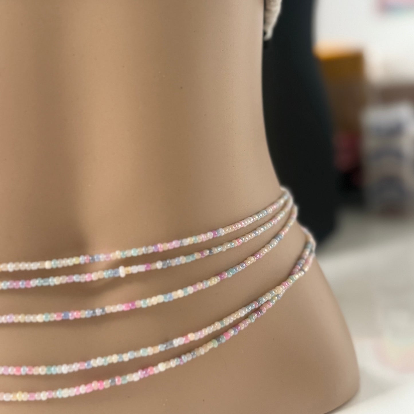 Close-up of Whispered Dream pastel waist beads featuring soft pink, lilac, baby blue, and cream glass beads. Handcrafted feminine waist jewelry designed for calm, balance, and gentle energy. Perfect accessory for women embracing softness, self-love, and everyday goddess vibes.
