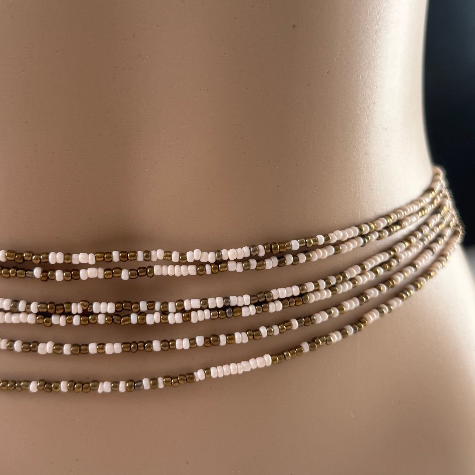 bronze beige tie on waist beads on waist, African waist beads, clasped waist beads, Bare Bronze waist beads worn by mannequin in natural light – neutral toned body jewellery for grounding and confidence