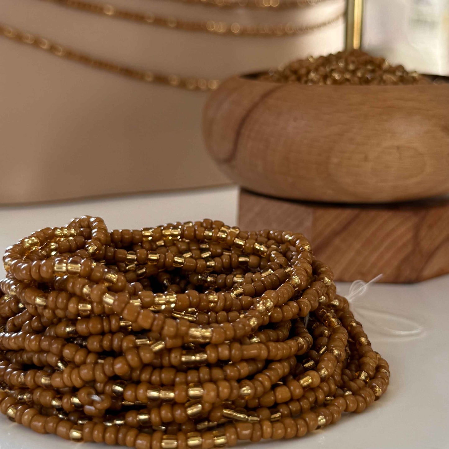 Brown Sugar Aura handmade waist beads with caramel brown and light gold glass beads, representing self-love, body positivity, and divine feminine energy. African-inspired waist jewellery for women embracing softness, sensuality, and intentional adornment.