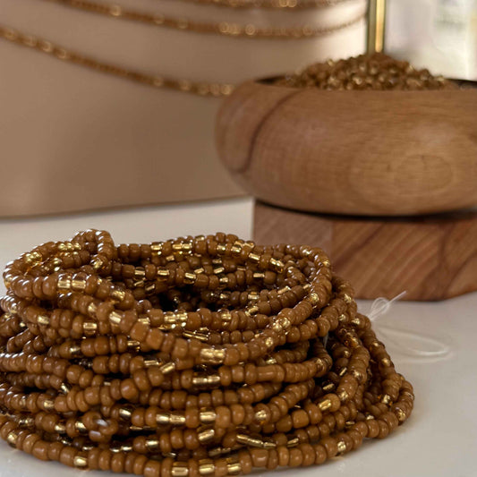 Brown Sugar Aura handmade waist beads with caramel brown and light gold glass beads, representing self-love, body positivity, and divine feminine energy. African-inspired waist jewellery for women embracing softness, sensuality, and intentional adornment.