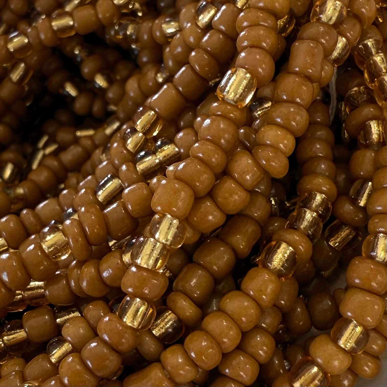 Brown Sugar Aura handmade waist beads with caramel brown and light gold glass beads, representing self-love, body positivity, and divine feminine energy. African-inspired waist jewelry for women embracing softness, sensuality, and intentional adornment.
