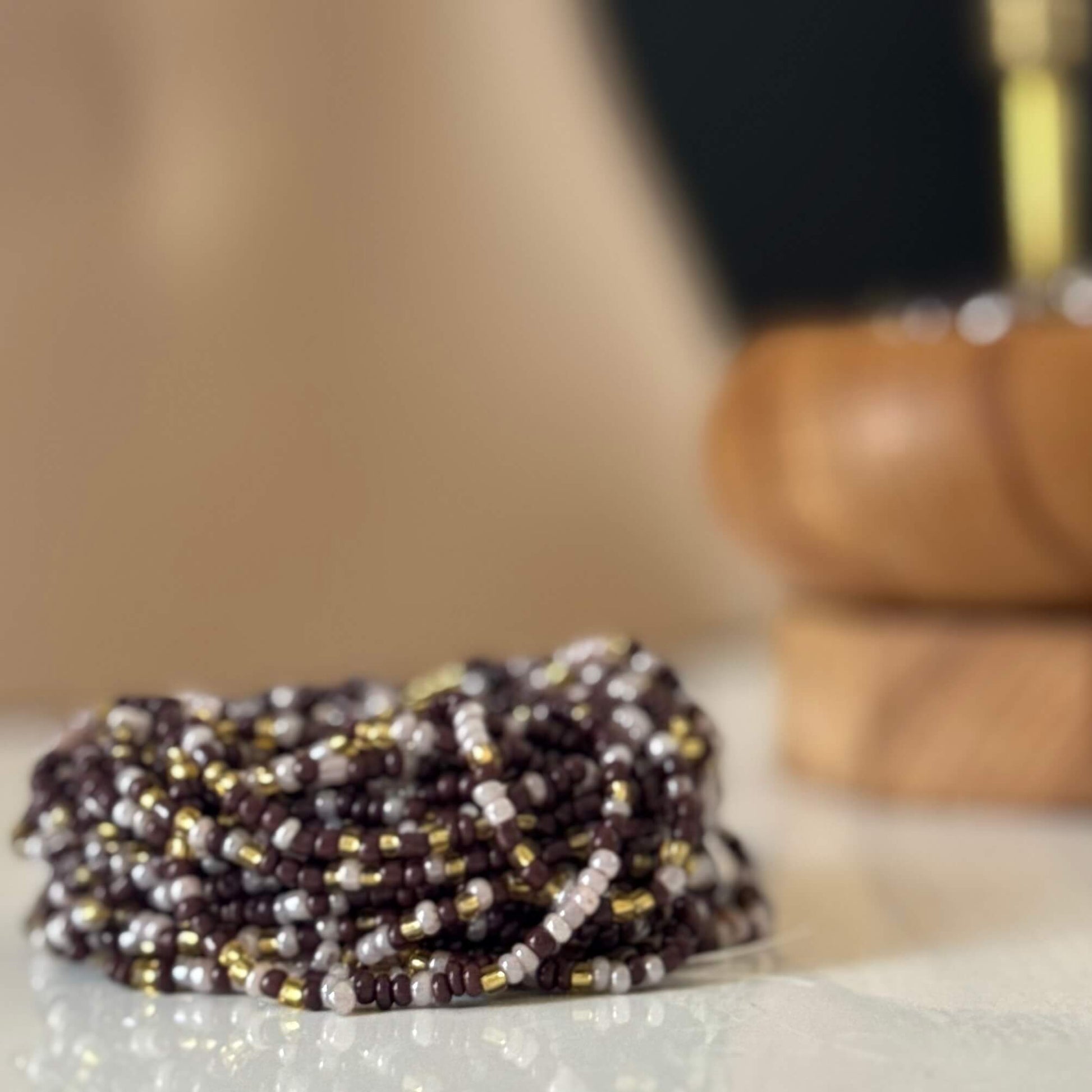 Earth & Ether waist beads for women, handcrafted with warm brown, soft lilac, and gold glass beads. Translucent lilac accents blend with earthy tones, symbolising balance, intuition, and feminine energy. Adjustable waist beads designed for self-love, spiritual growth, and grounded confidence.