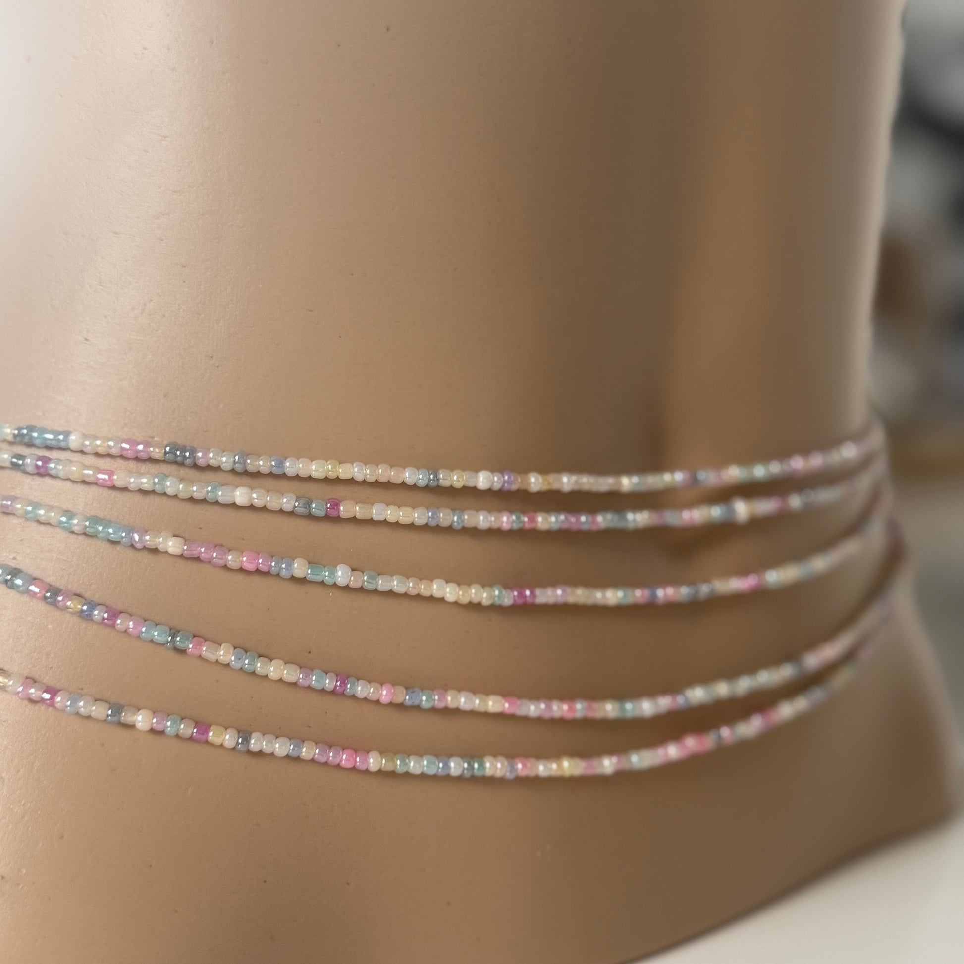 Close-up of Whispered Dream pastel waist beads featuring soft pink, lilac, baby blue, and cream glass beads. Handcrafted feminine waist jewelry designed for calm, balance, and gentle energy. Perfect accessory for women embracing softness, self-love, and everyday goddess vibes.