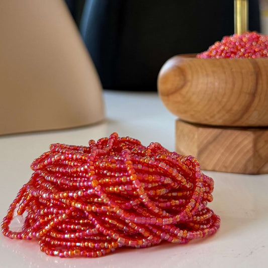 Translucent red waist beads handcrafted with vibrant red glass beads, perfect body jewellery to celebrate feminine power, passion, and confidence. Adjustable, stylish waist beads for everyday wear or special occasions.